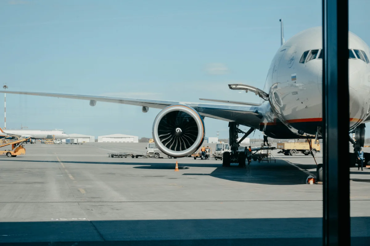 Jet airliner on the tarmac with cargo being loaded.