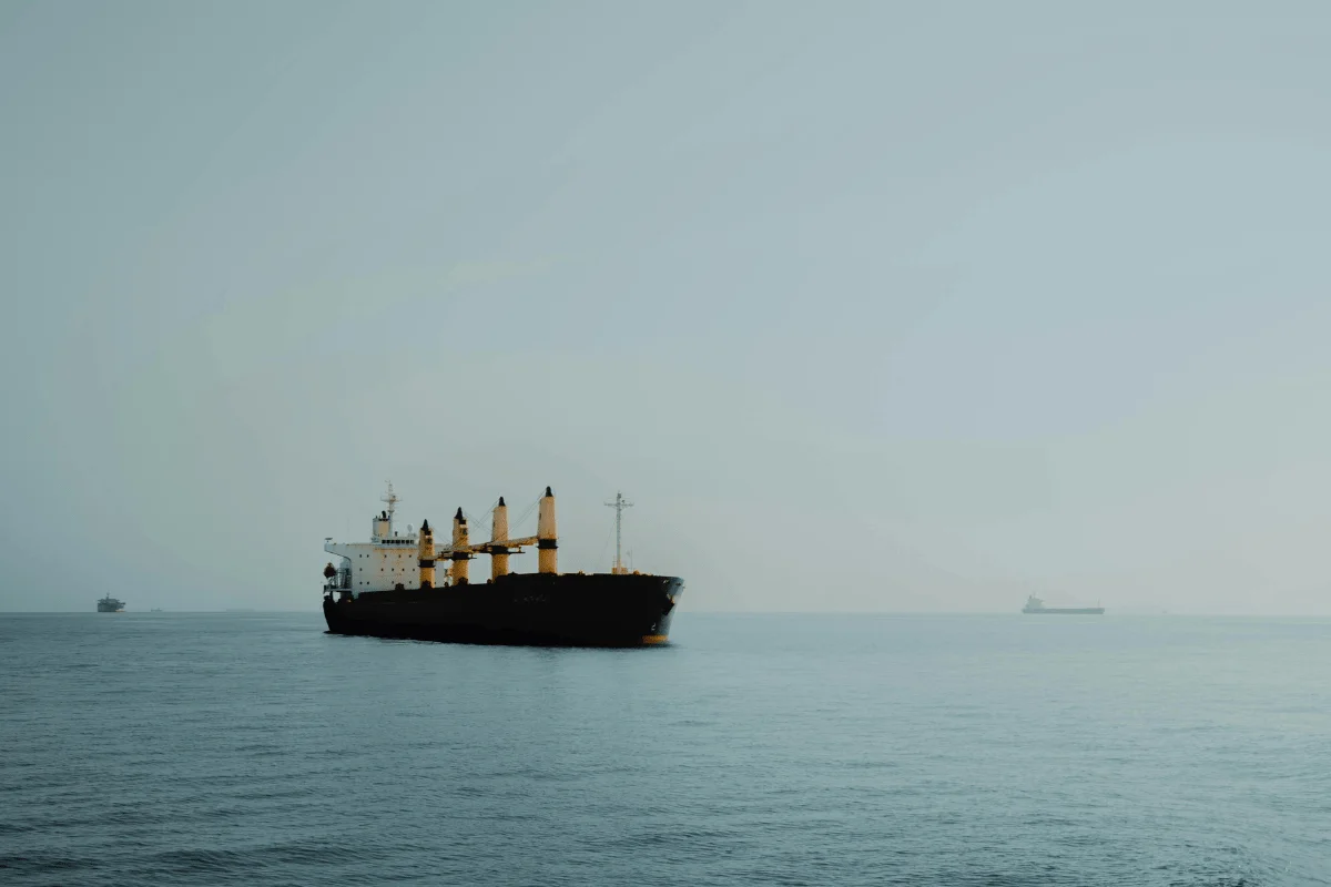 A large container ship sailing through calm waters.