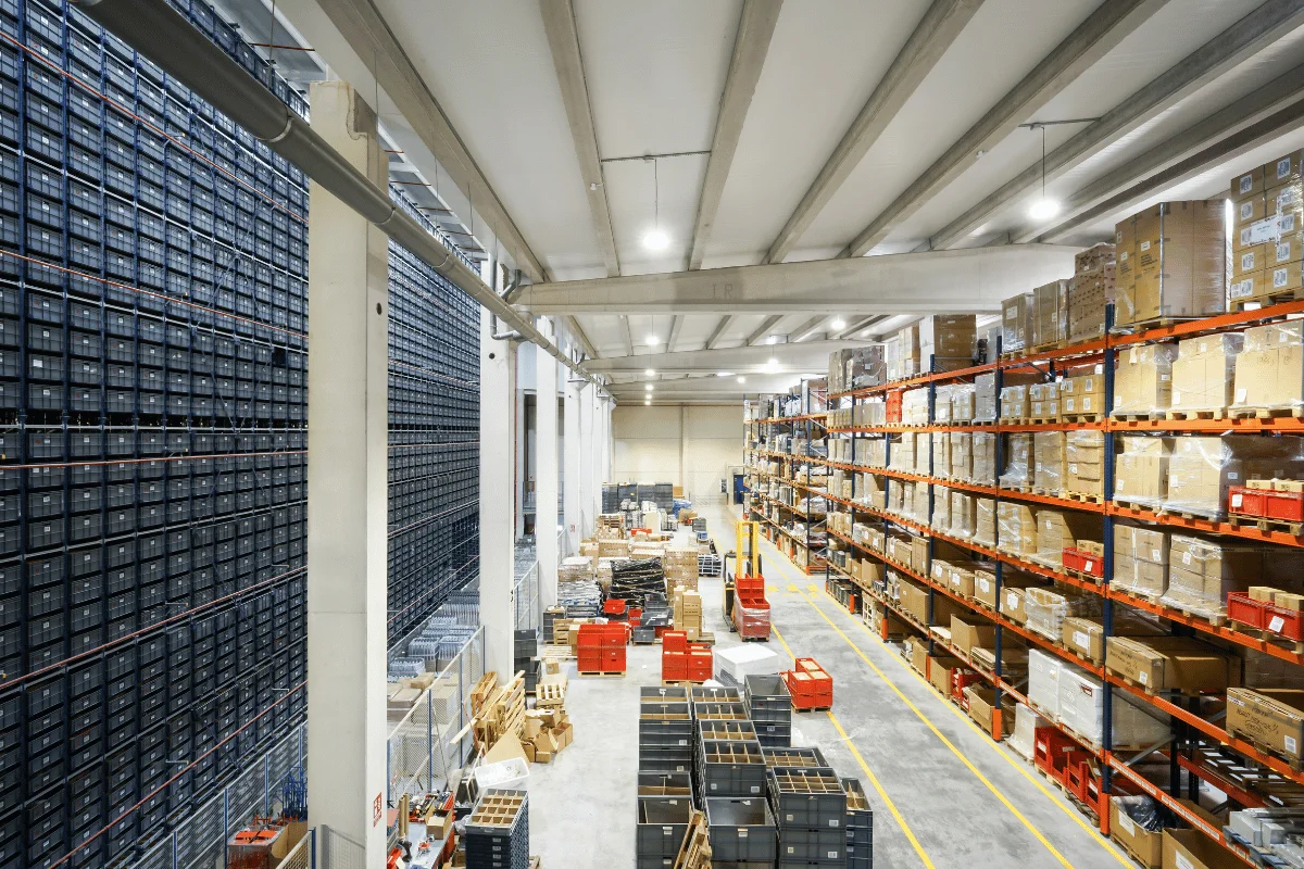 Wide-angle view of a well-organized warehouse with shelves filled with boxes.