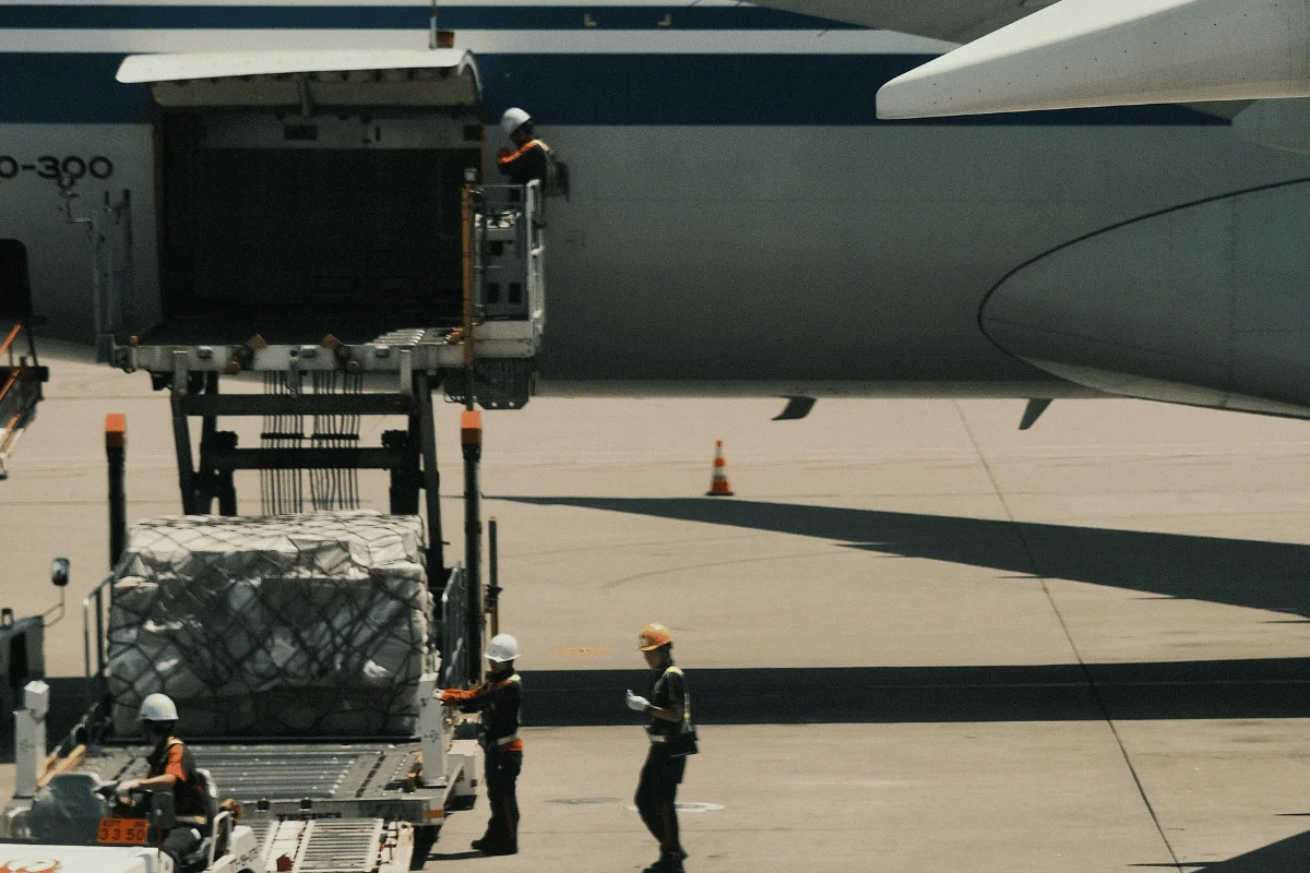 Airport ground crew handling air freight.