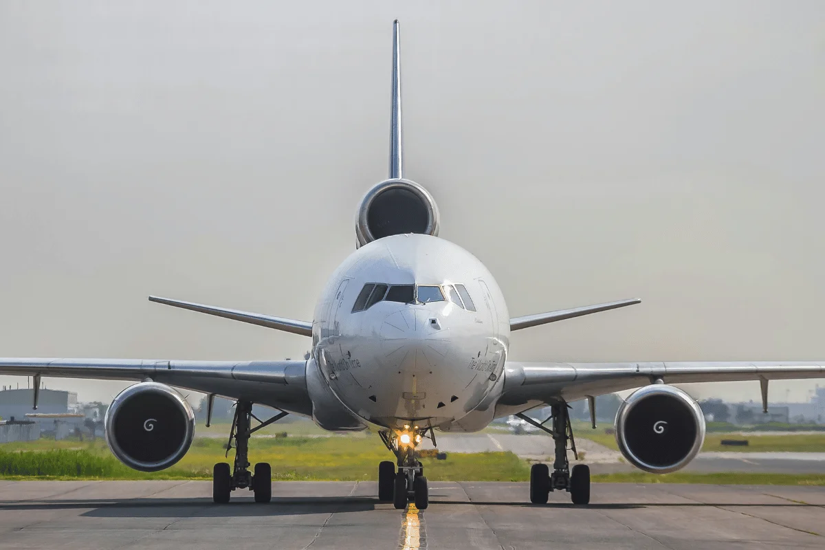 Large passenger jetliner stationed on the airport runway.