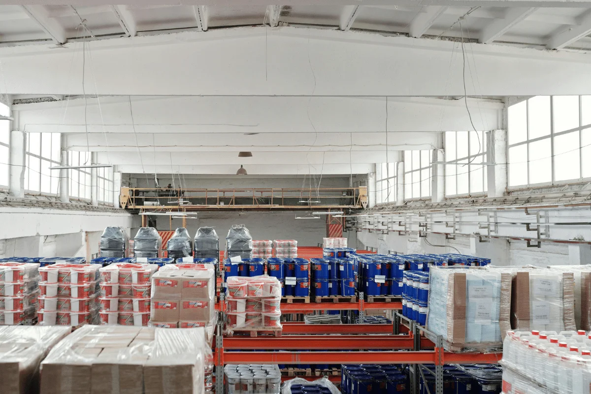 Warehouse with shelves stocked with various products.