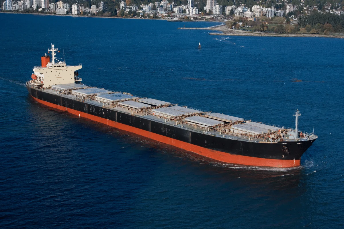 Top West Coast Container Ports: A Business Guide for Importers 7 Commercial freight ship navigating through coastal waters.