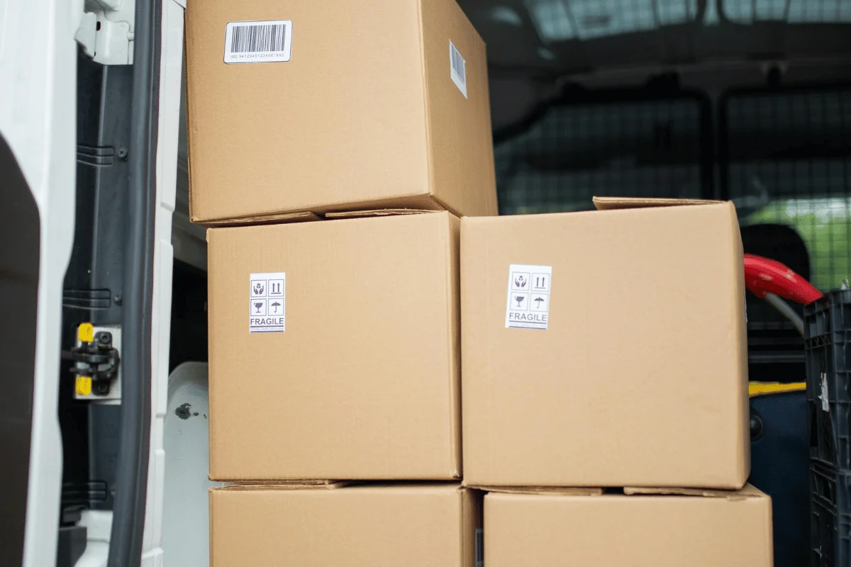 How to Import Toys From China: A Step-by-Step Guide 25 Stack of cardboard boxes labeled as fragile inside a delivery van.