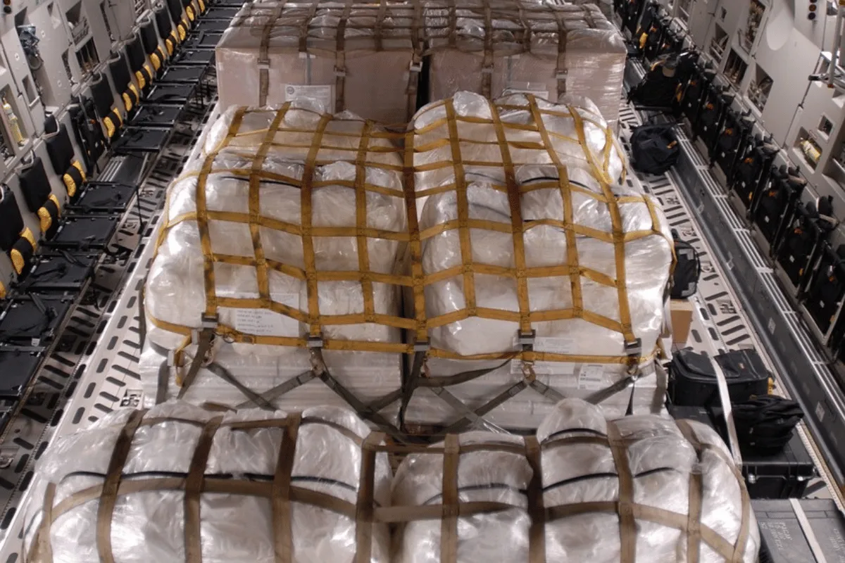 Cargo bundles neatly organized and strapped within an aircraft's cabin.