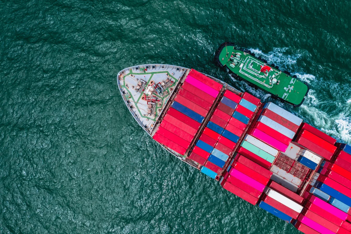 Overhead shot of a freight vessel transporting stacked containers.