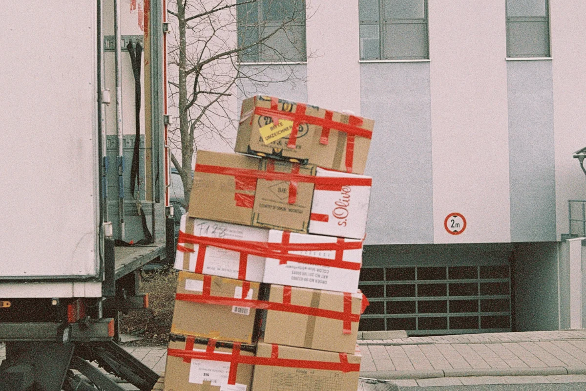 How to Import Toys From China: A Step-by-Step Guide 17 Boxes secured with red tape being moved for delivery.