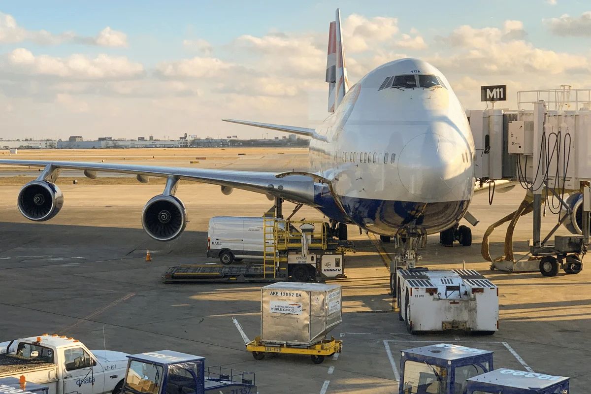 Large passenger plane being prepared for flight with cargo operations.