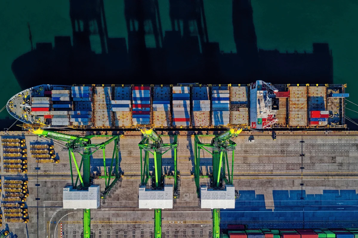 Container ship being unloaded at a shipping terminal.