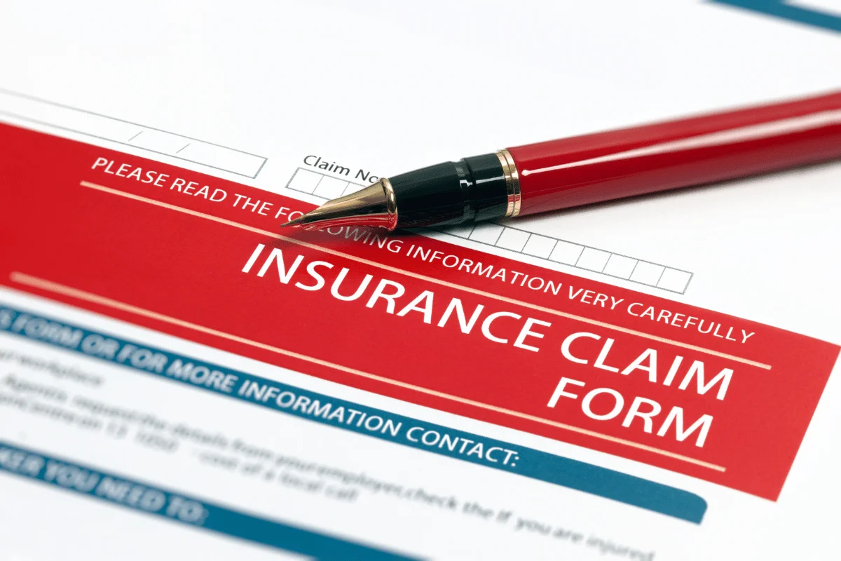 Shipping from Thailand to the USA: Challenges, Solutions & More 10 Close-up of an insurance claim form with a red pen on top.