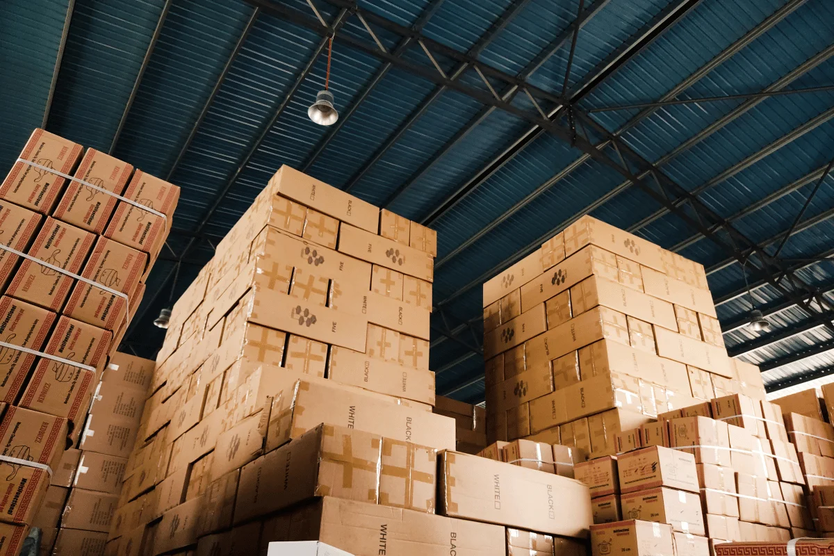 Stacks of cardboard boxes neatly arranged in a warehouse.
