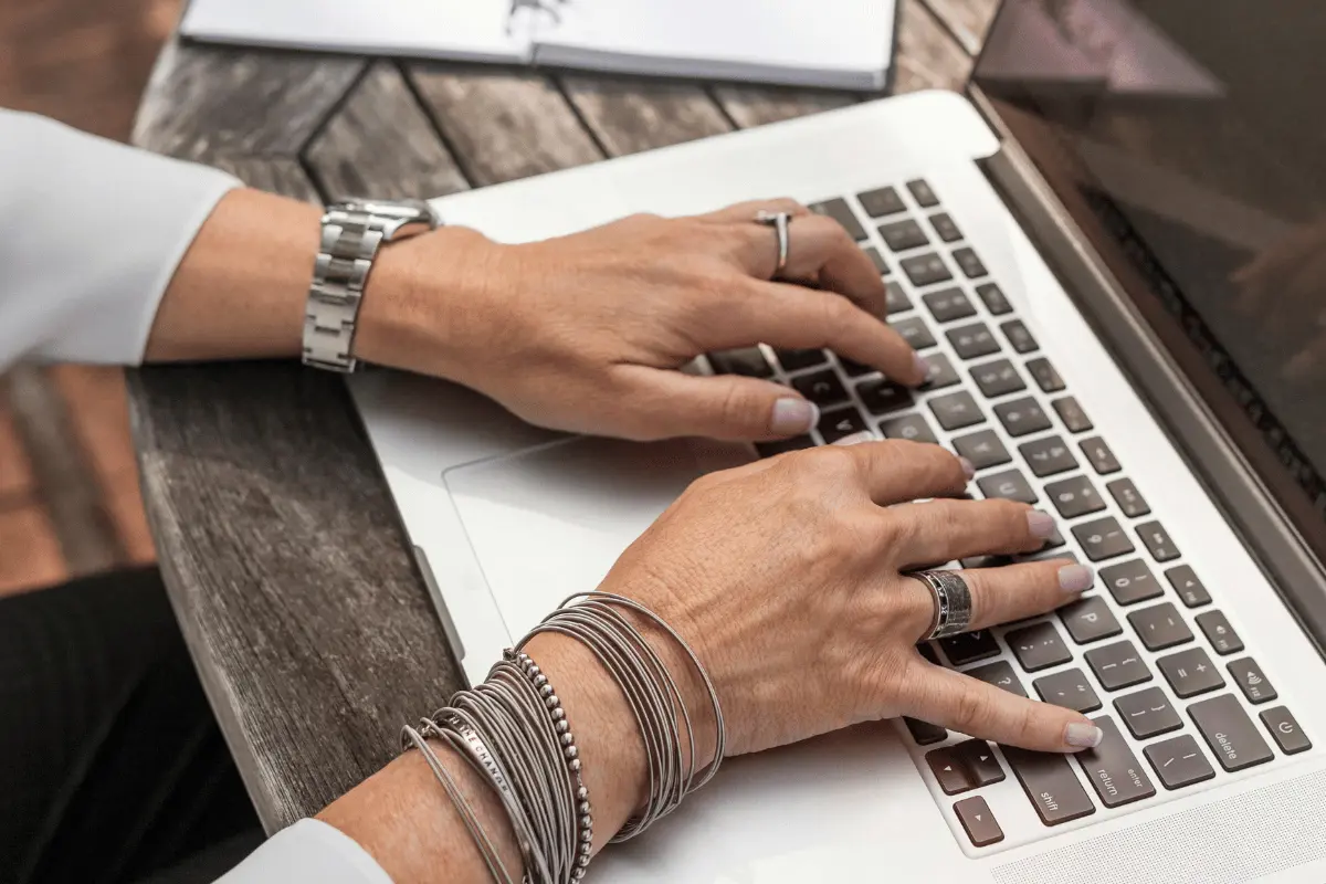 Digital Freight Forwarding Companies - Are They Beneficial? 7 Close-up of hands with silver bracelets typing on a keyboard.