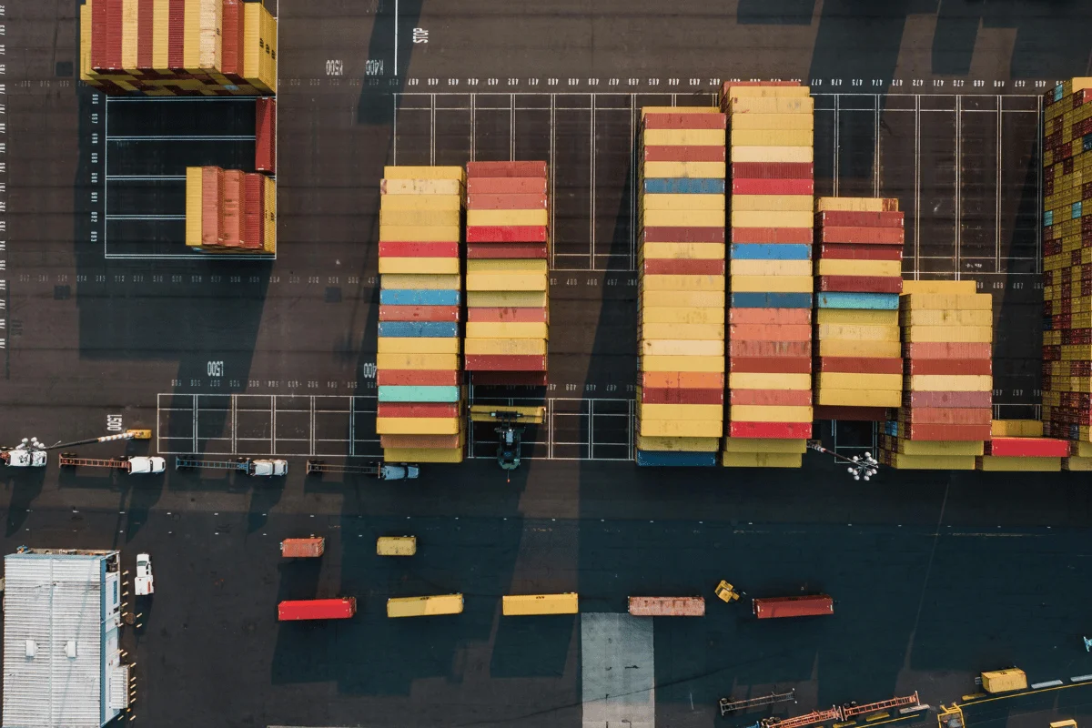How to Choose the Best Freight Forwarder From China to USA 11 Top-down perspective of organized cargo containers at a port.