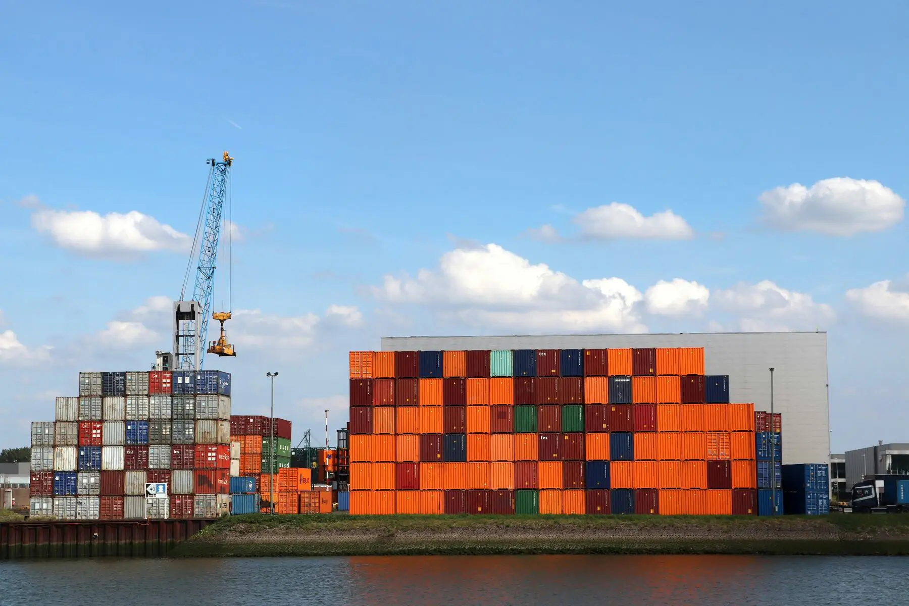 An Importer's Guide to CMT Clothing Manufacturers 5 Image of loaded cargo ship moored at a port.