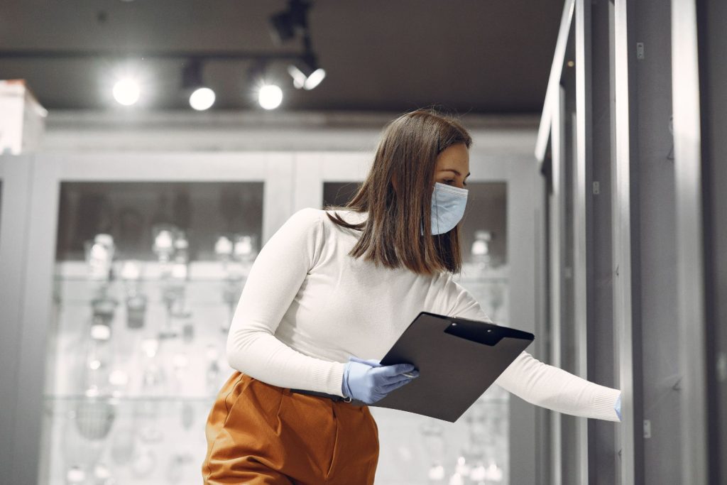 Woman inside a commercial business checking that installed racks are fine.