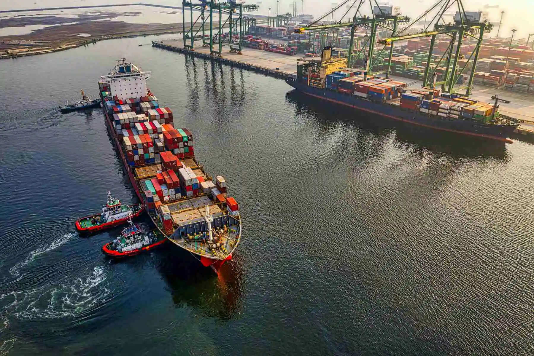 2 cargo ships loaded with containers by a commercial port terminal
